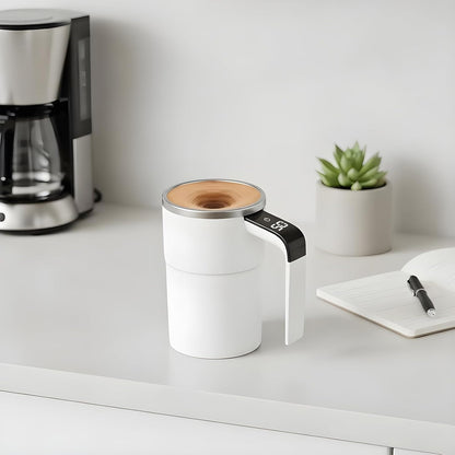White coffee maker on a kitchen counter with a plant and notebook in the background